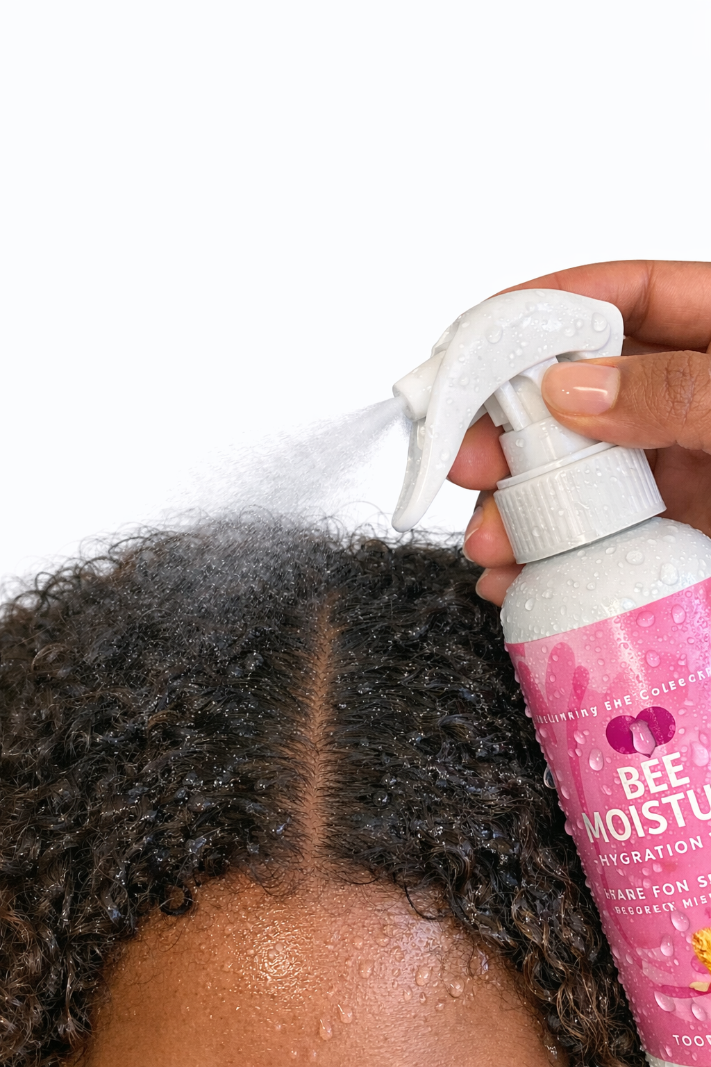Bee Moisture Hydration Mist being sprayed onto the scalp